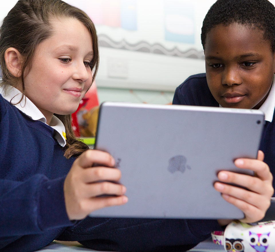 Two students looking at an iPad