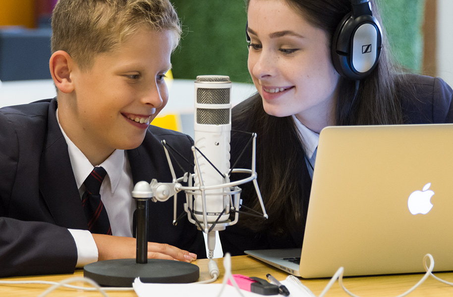 Students recording on a microphone