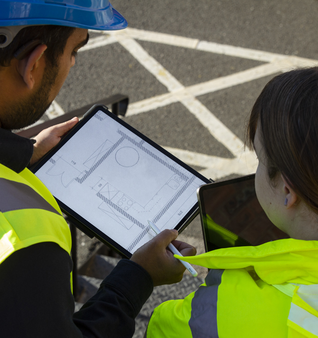 Two construction workers using iPad